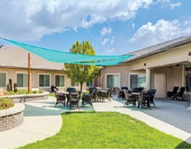 A large patio with a blue canopy and several chairs and tables. AI generated content